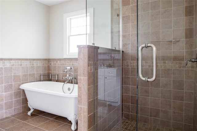 1145 Bay Haven Ln, Southold, NY 11971 - bathroom featuring tile walls, a stall shower, a soaking tub, tile patterned floors, and a wainscoted wall