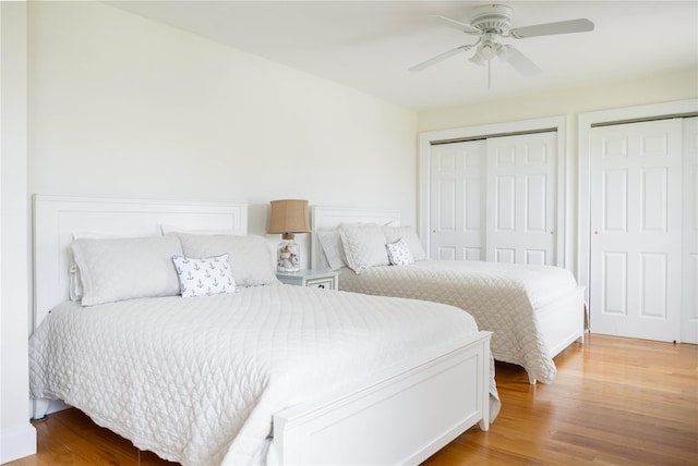 1145 Bay Haven Ln, Southold, NY 11971 - bedroom with wood finished floors, two closets, and a ceiling fan