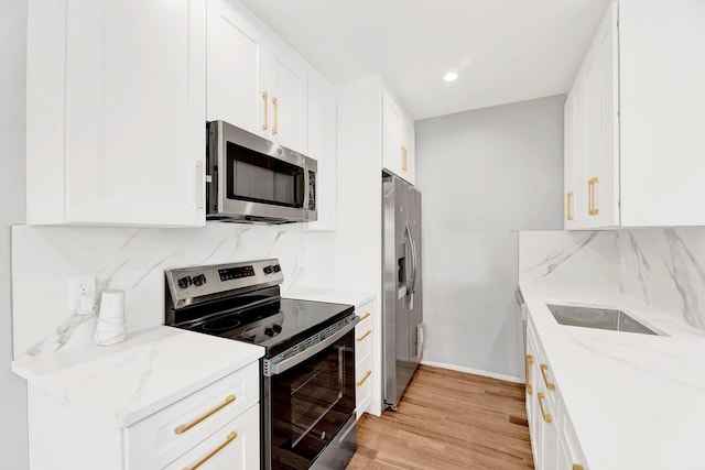 3780 Willett Ave, Bronx, NY 10467 - kitchen with stainless steel appliances, tasteful backsplash, light wood-style floors, white cabinets, and recessed lighting