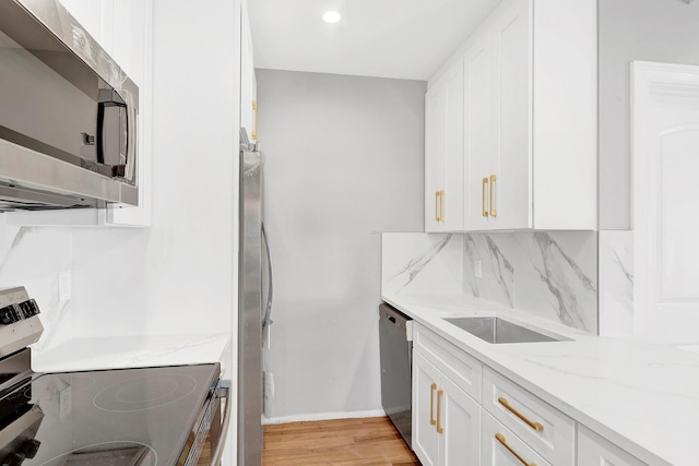 3780 Willett Ave, Bronx, NY 10467 - kitchen with stainless steel appliances, white cabinetry, light stone countertops, and recessed lighting