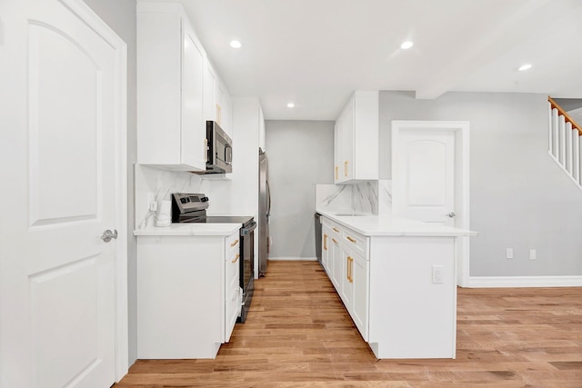 3780 Willett Ave, Bronx, NY 10467 - kitchen with stainless steel appliances, light wood-style floors, recessed lighting, white cabinets, and light countertops