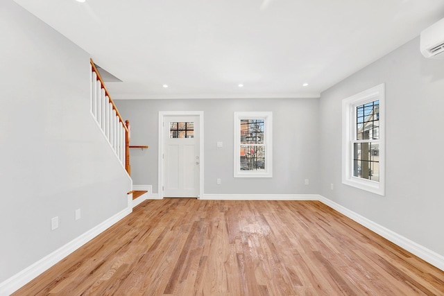 3780 Willett Ave, Bronx, NY 10467 - foyer featuring stairway, light wood finished floors, baseboards, an AC wall unit, and recessed lighting