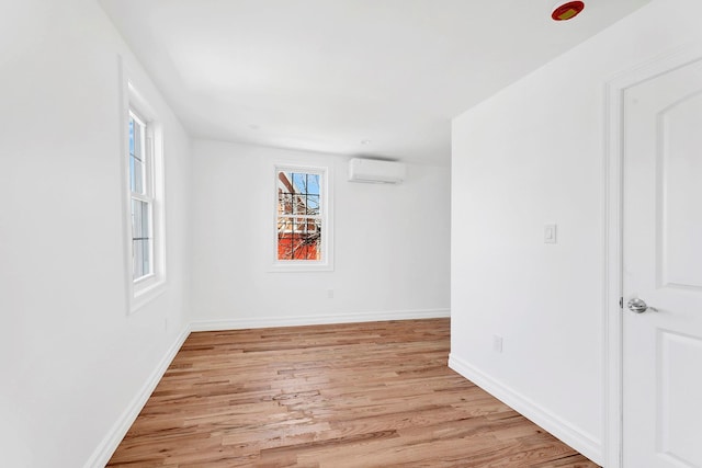 3780 Willett Ave, Bronx, NY 10467 - unfurnished room with a wall mounted AC, light wood-type flooring, and baseboards