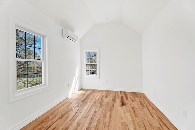 3780 Willett Ave, Bronx, NY 10467 - additional living space with a wall unit AC, light wood-style flooring, baseboards, and vaulted ceiling