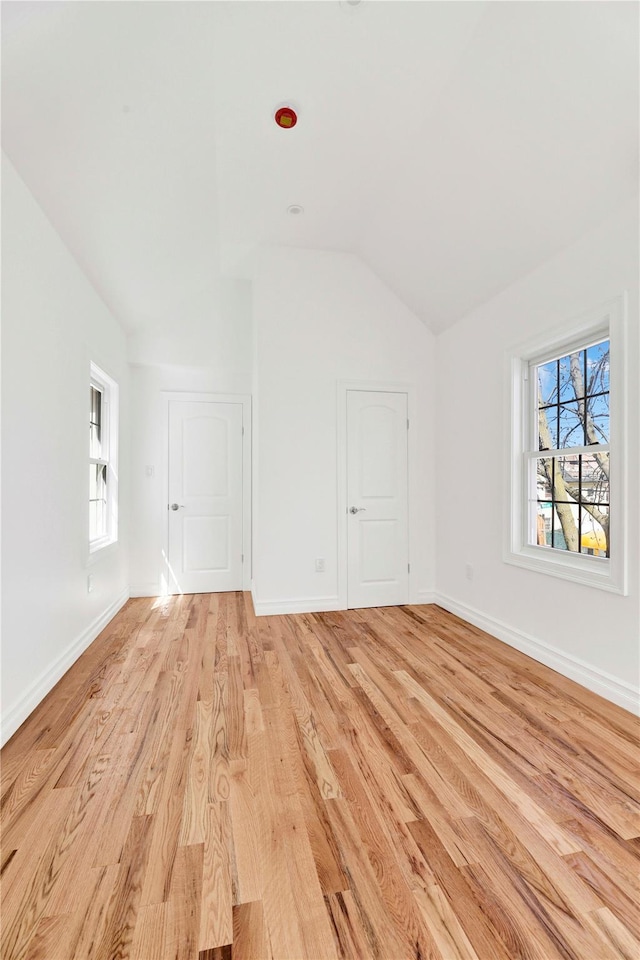 3780 Willett Ave, Bronx, NY 10467 - unfurnished room with vaulted ceiling, light wood-style floors, and baseboards