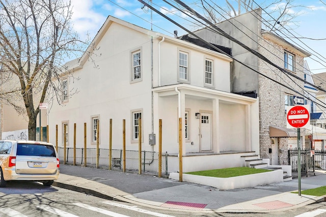 3780 Willett Ave, Bronx, NY 10467 - view of front facade with stucco siding and fence