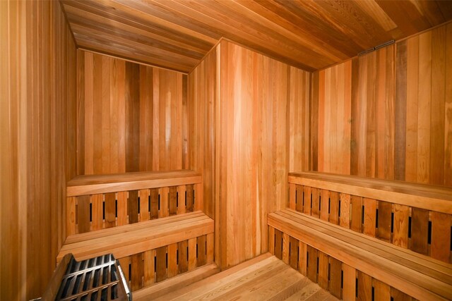 relaxing sauna / steam room with wood ceiling and wooden walls