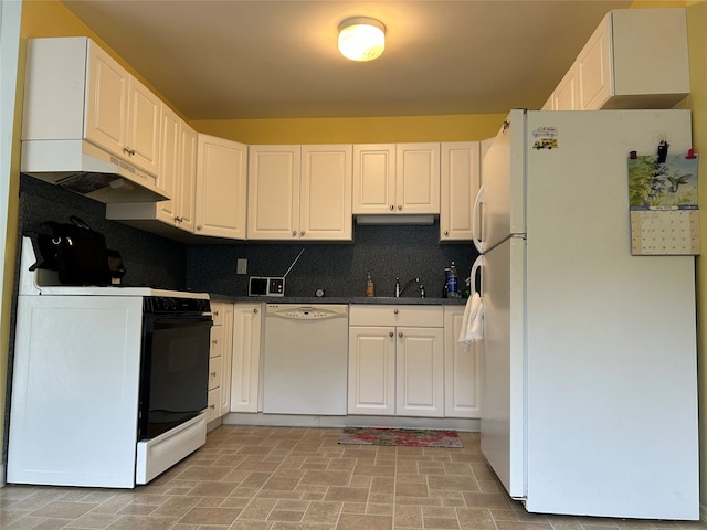 10 Monet Ct Unit 10, Middle Island, NY 11953 - kitchen with white appliances, under cabinet range hood, dark countertops, a sink, and white cabinetry