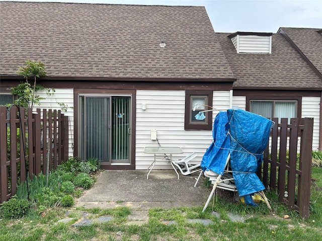 10 Monet Ct Unit 10, Middle Island, NY 11953 - rear view of house with a shingled roof, a patio, and fence