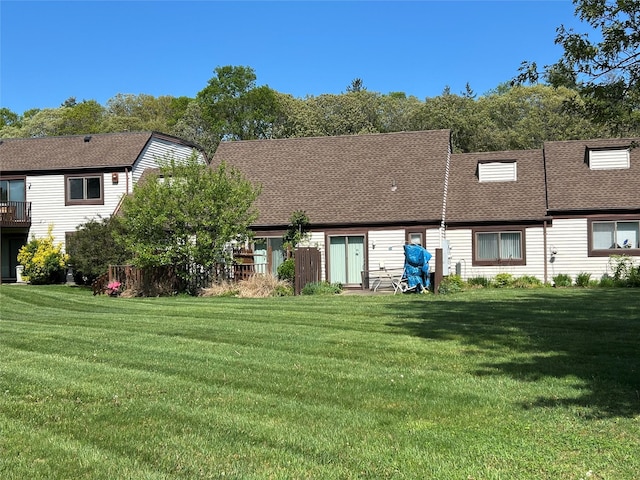 10 Monet Ct Unit 10, Middle Island, NY 11953 - rear view of property with a yard and a shingled roof