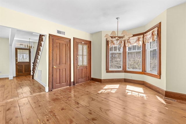 25105 Main Rd, Orient, NY 11957 - entryway featuring a chandelier, hardwood / wood-style flooring, stairs, and baseboards