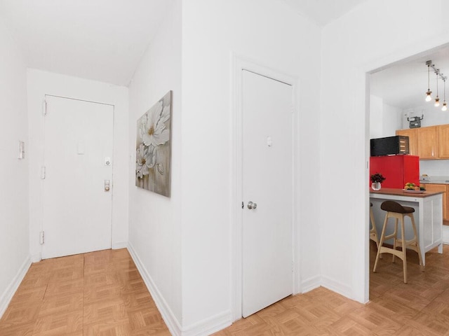 corridor featuring baseboards