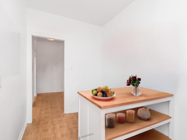 hallway featuring baseboards