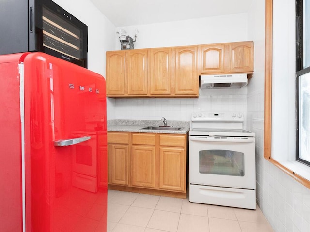 kitchen with white electric range, under cabinet range hood, a sink, fridge, and light countertops