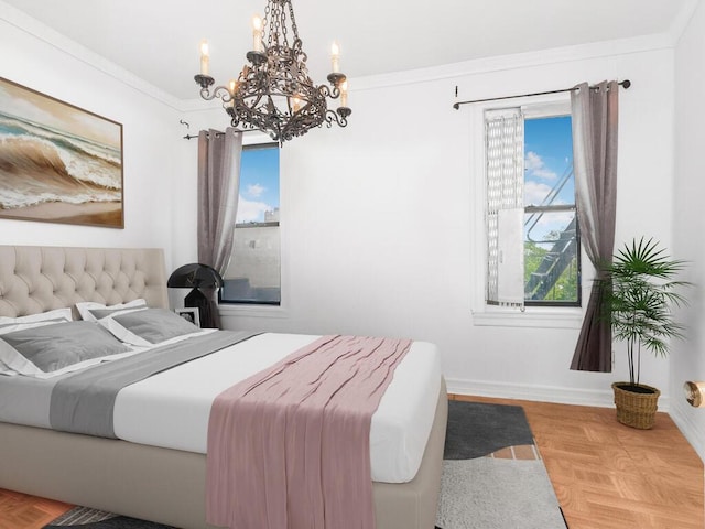 bedroom featuring a chandelier, baseboards, and ornamental molding