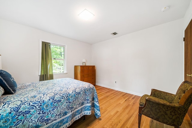 bedroom featuring wood finished floors and baseboards