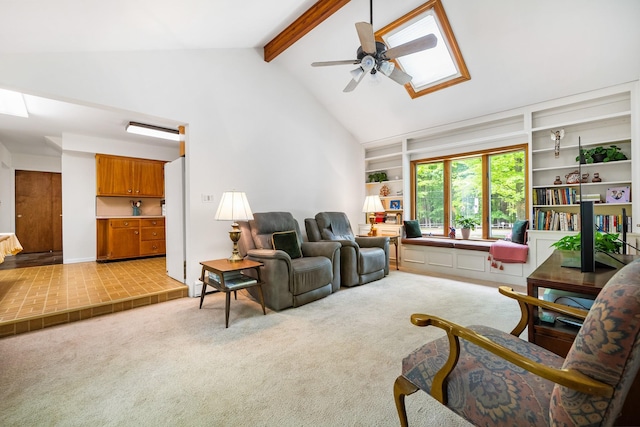 carpeted living room featuring a skylight and ceiling fan