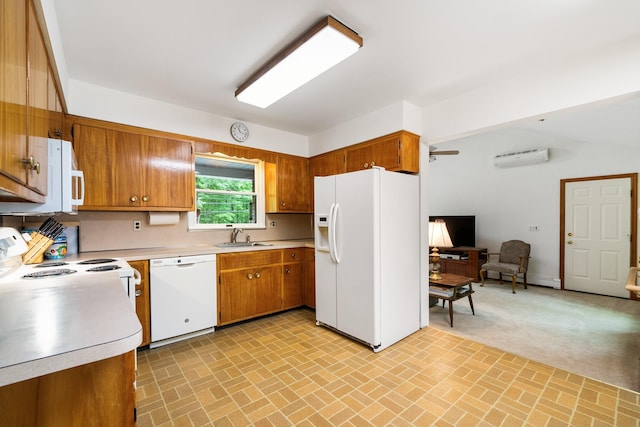 kitchen with white appliances, a sink, brown cabinets, light countertops, and brick patterned flooring