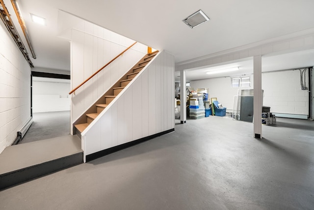 below grade area with concrete block wall and stairs