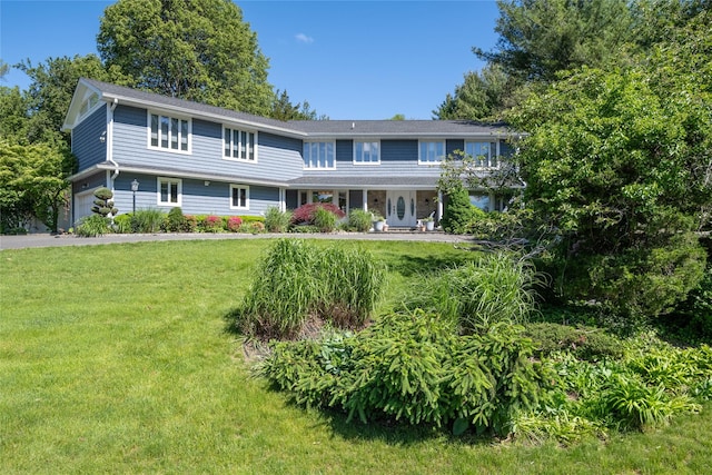 1 Anvil Ct, Dix Hills, NY 11746 - view of front facade featuring a front lawn, an attached garage, and asphalt driveway