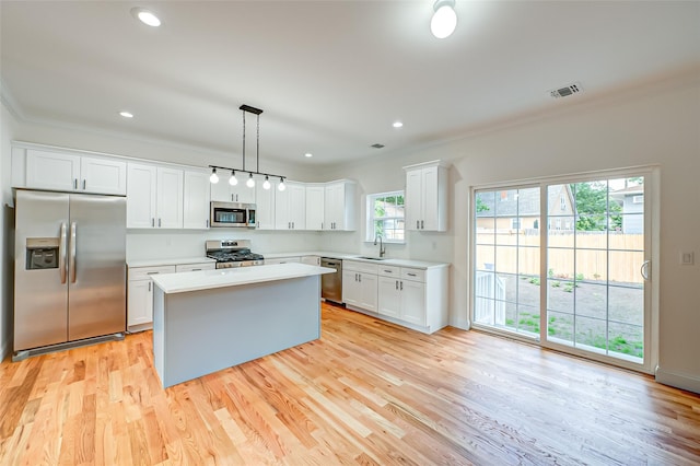 36-A Maple Ave, Port Jefferson Station, NY 11776 - kitchen with appliances with stainless steel finishes, ornamental molding, a sink, light countertops, and white cabinets