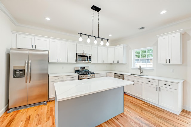 36-A Maple Ave, Port Jefferson Station, NY 11776 - kitchen featuring stainless steel appliances, a sink, ornamental molding, a kitchen island, and white cabinetry