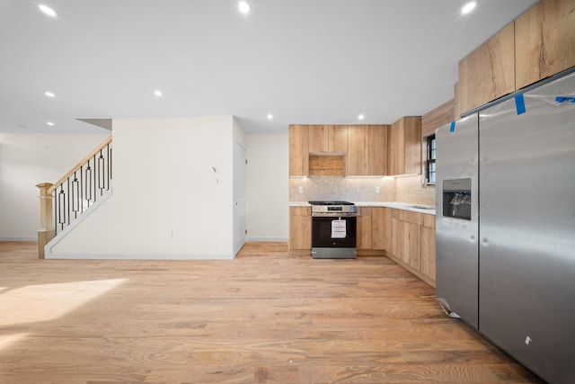 486 Ashford St, Brooklyn, NY 11207 - kitchen featuring stainless steel appliances, light countertops, light wood-style floors, tasteful backsplash, and recessed lighting