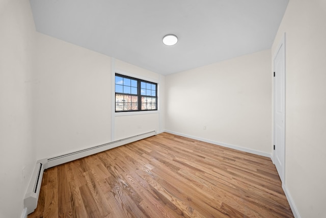 486 Ashford St, Brooklyn, NY 11207 - unfurnished room featuring a baseboard heating unit, wood finished floors, and baseboards