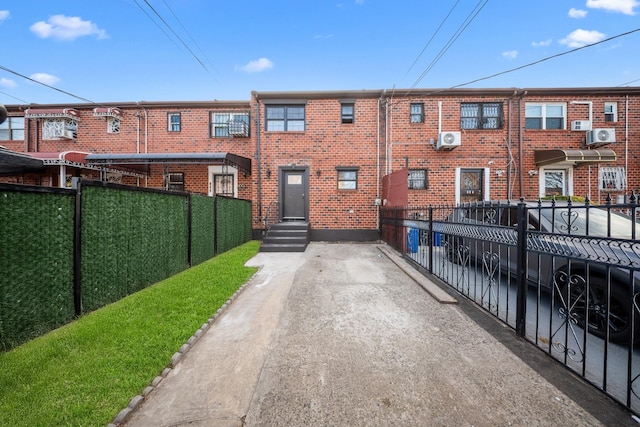 486 Ashford St, Brooklyn, NY 11207 - view of front of home featuring fence, brick siding, and a cooling unit