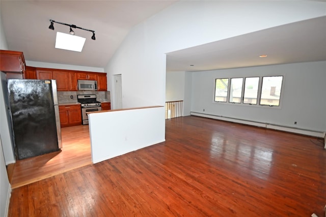 51 Manor Rd, Valley Stream, NY 11580 - kitchen with stainless steel appliances, track lighting, light wood-type flooring, open floor plan, and a skylight