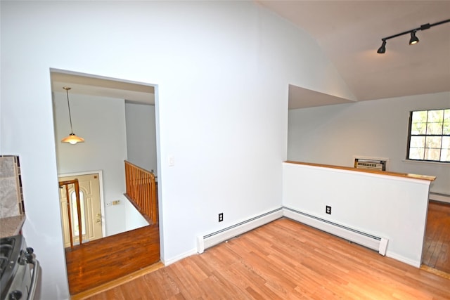 51 Manor Rd, Valley Stream, NY 11580 - empty room featuring vaulted ceiling, track lighting, wood finished floors, and a baseboard heating unit