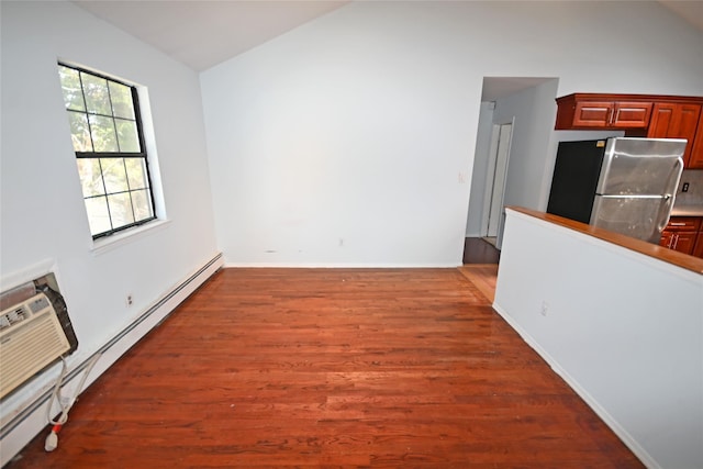 51 Manor Rd, Valley Stream, NY 11580 - empty room featuring vaulted ceiling, a baseboard radiator, wood finished floors, and baseboards