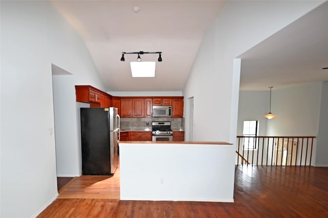 51 Manor Rd, Valley Stream, NY 11580 - kitchen with appliances with stainless steel finishes, light wood-style floors, tasteful backsplash, high vaulted ceiling, and baseboards