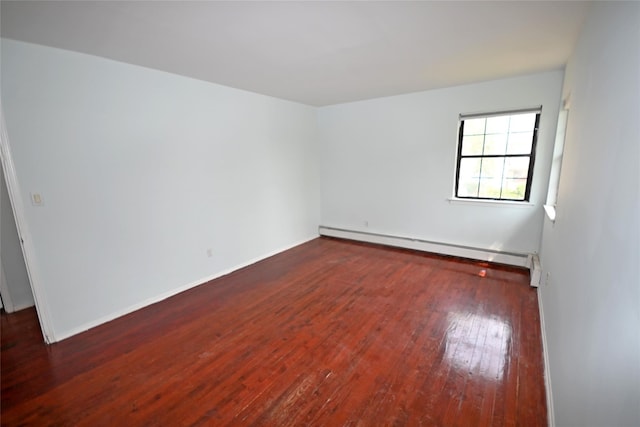 51 Manor Rd, Valley Stream, NY 11580 - empty room with a baseboard heating unit, hardwood / wood-style floors, and baseboards