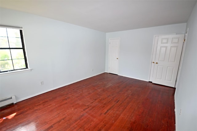 51 Manor Rd, Valley Stream, NY 11580 - unfurnished room with wood finished floors, baseboard heating, and baseboards