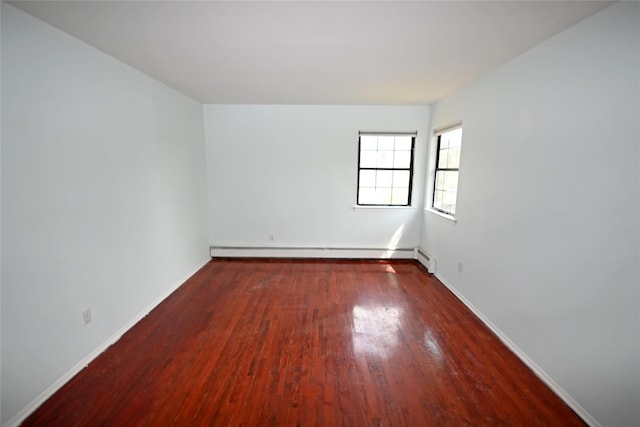 51 Manor Rd, Valley Stream, NY 11580 - empty room with a baseboard heating unit, wood finished floors, and baseboards