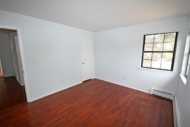 51 Manor Rd, Valley Stream, NY 11580 - spare room featuring dark wood-style floors, baseboard heating, and baseboards