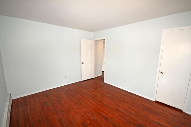 51 Manor Rd, Valley Stream, NY 11580 - empty room featuring a baseboard heating unit, wood finished floors, and baseboards