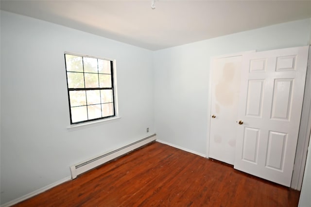51 Manor Rd, Valley Stream, NY 11580 - spare room with baseboard heating, wood finished floors, and baseboards