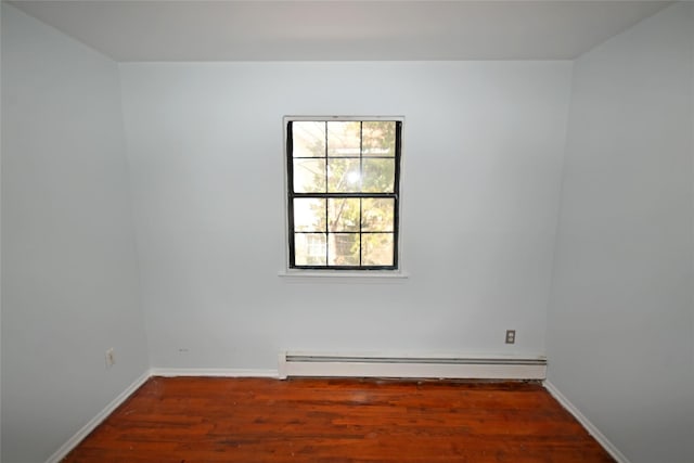 51 Manor Rd, Valley Stream, NY 11580 - spare room with a baseboard heating unit, wood finished floors, and baseboards