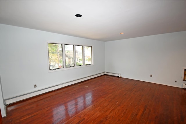 51 Manor Rd, Valley Stream, NY 11580 - empty room with a baseboard radiator, wood finished floors, and baseboards