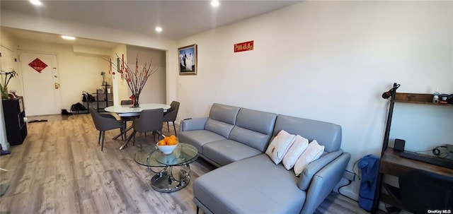 living area with light wood finished floors and recessed lighting