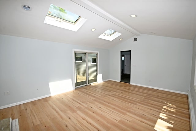 unfurnished room featuring a skylight, light wood-style floors, baseboards, and recessed lighting