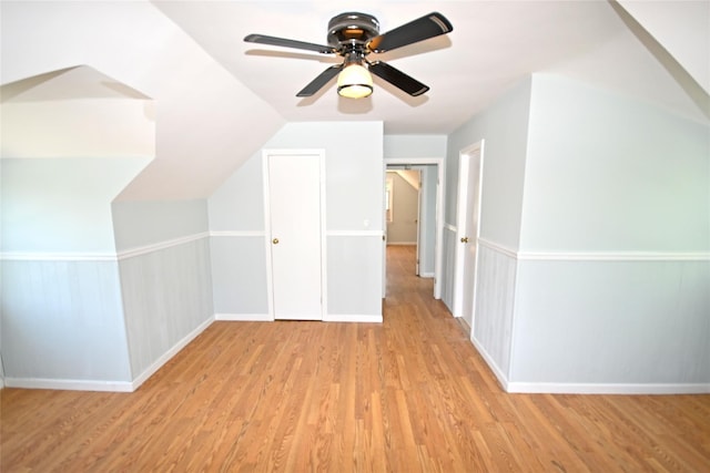 bonus room with wood finished floors, a ceiling fan, baseboards, and lofted ceiling