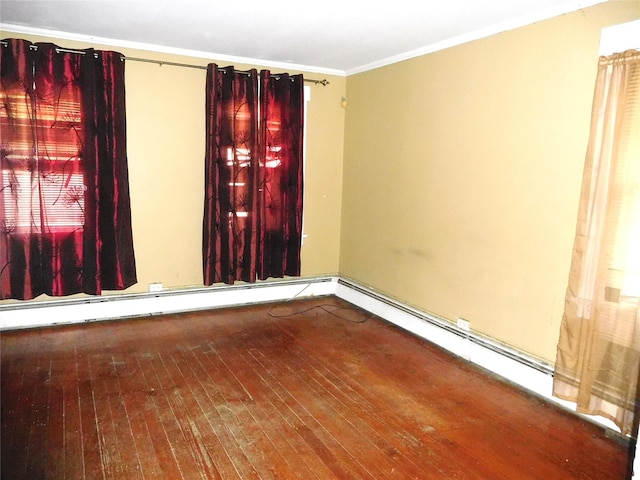 unfurnished room featuring hardwood / wood-style floors, ornamental molding, and a baseboard radiator