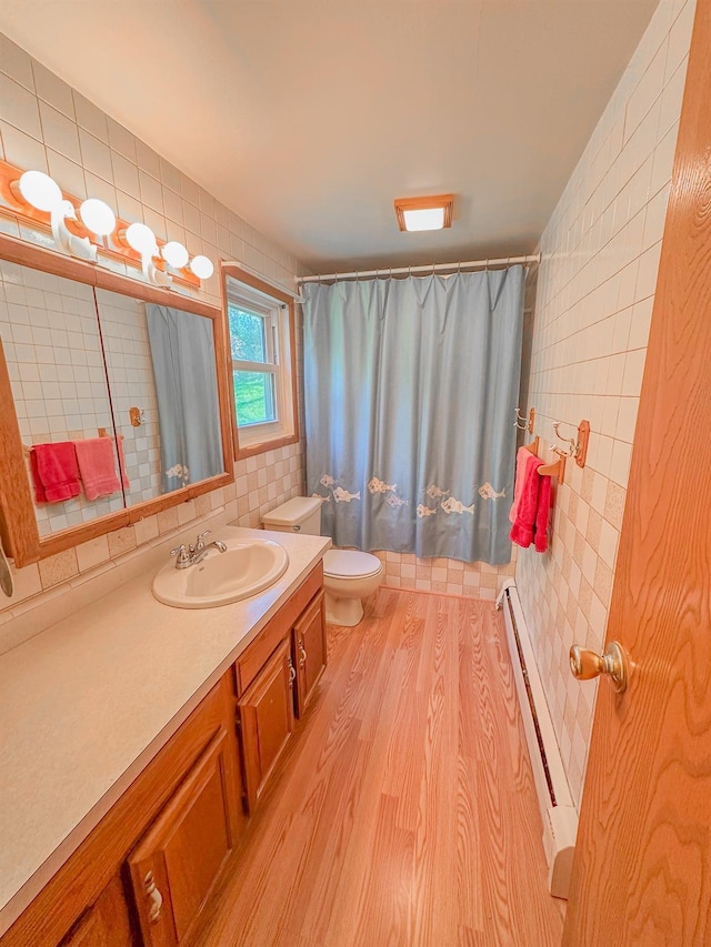 15 Feller Newmark Rd, Red Hook, NY 12571 - full bath with baseboard heating, toilet, tile walls, vanity, and wood finished floors