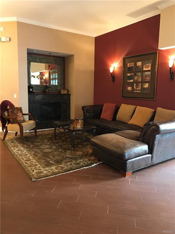 100 New Roc City Pl Unit 408, New Rochelle, NY 10801 - living room featuring ornamental molding, a fireplace, and wood finished floors