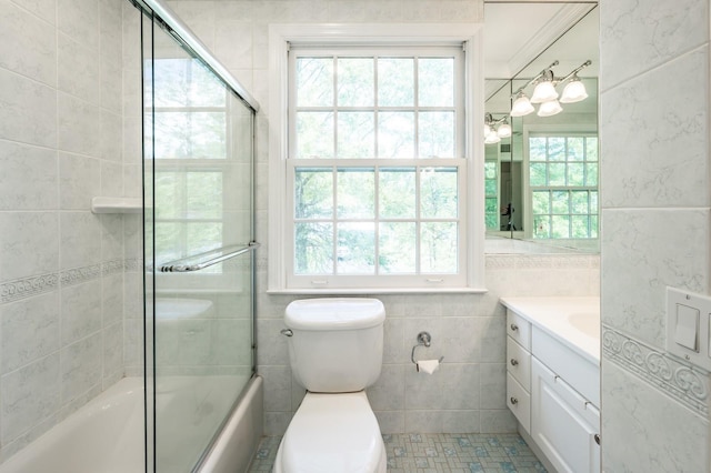 16 Cayuga Rd, Scarsdale, NY 10583 - full bathroom featuring vanity, shower / bath combination with glass door, toilet, and tile walls