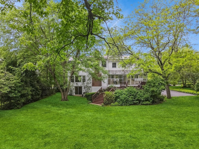 16 Cayuga Rd, Scarsdale, NY 10583 - back of property with stairway, a sunroom, a yard, and a wooden deck
