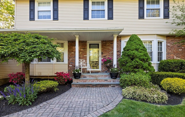 90 Gannet Dr, Commack, NY 11725 - property entrance featuring covered porch and brick siding